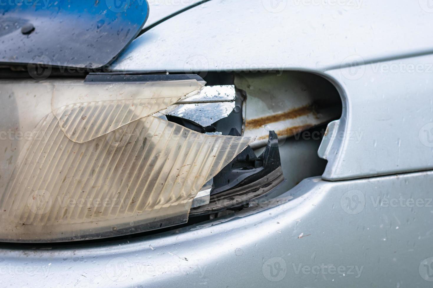 Broken headlight of a car after a minor collision due to dangerous driving photo
