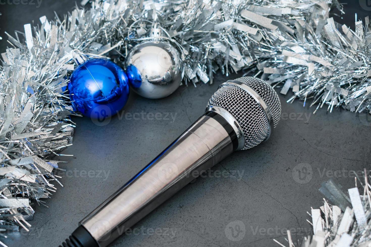 Silver music microphone and Christmas decorations during New Years party photo