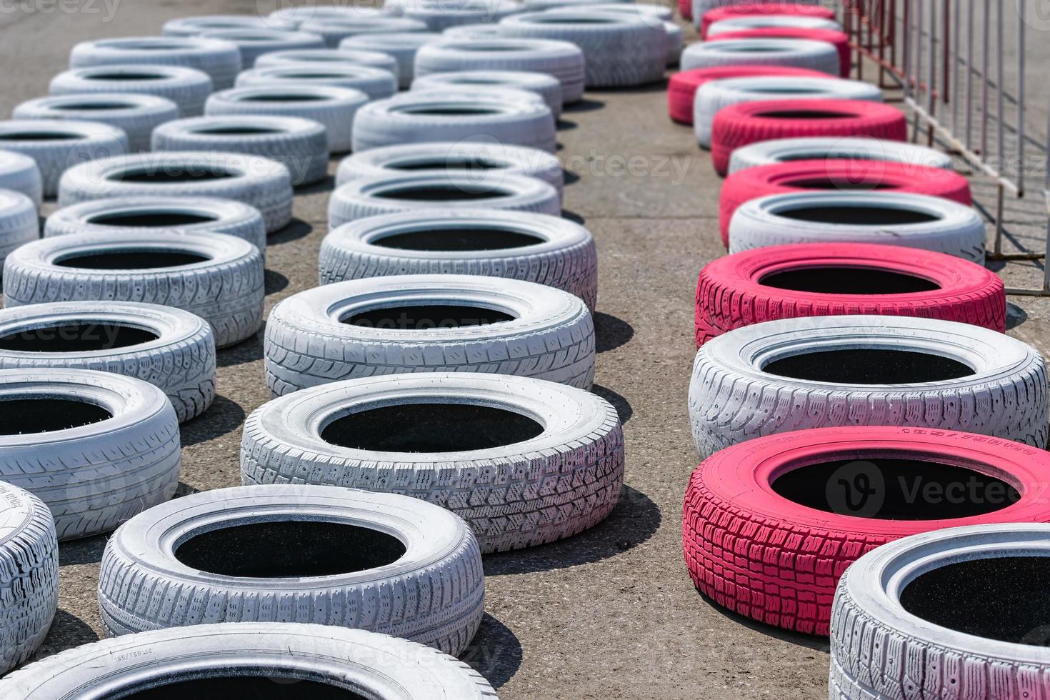 Tires lying on the track of the race track for safety in case of accidents photo