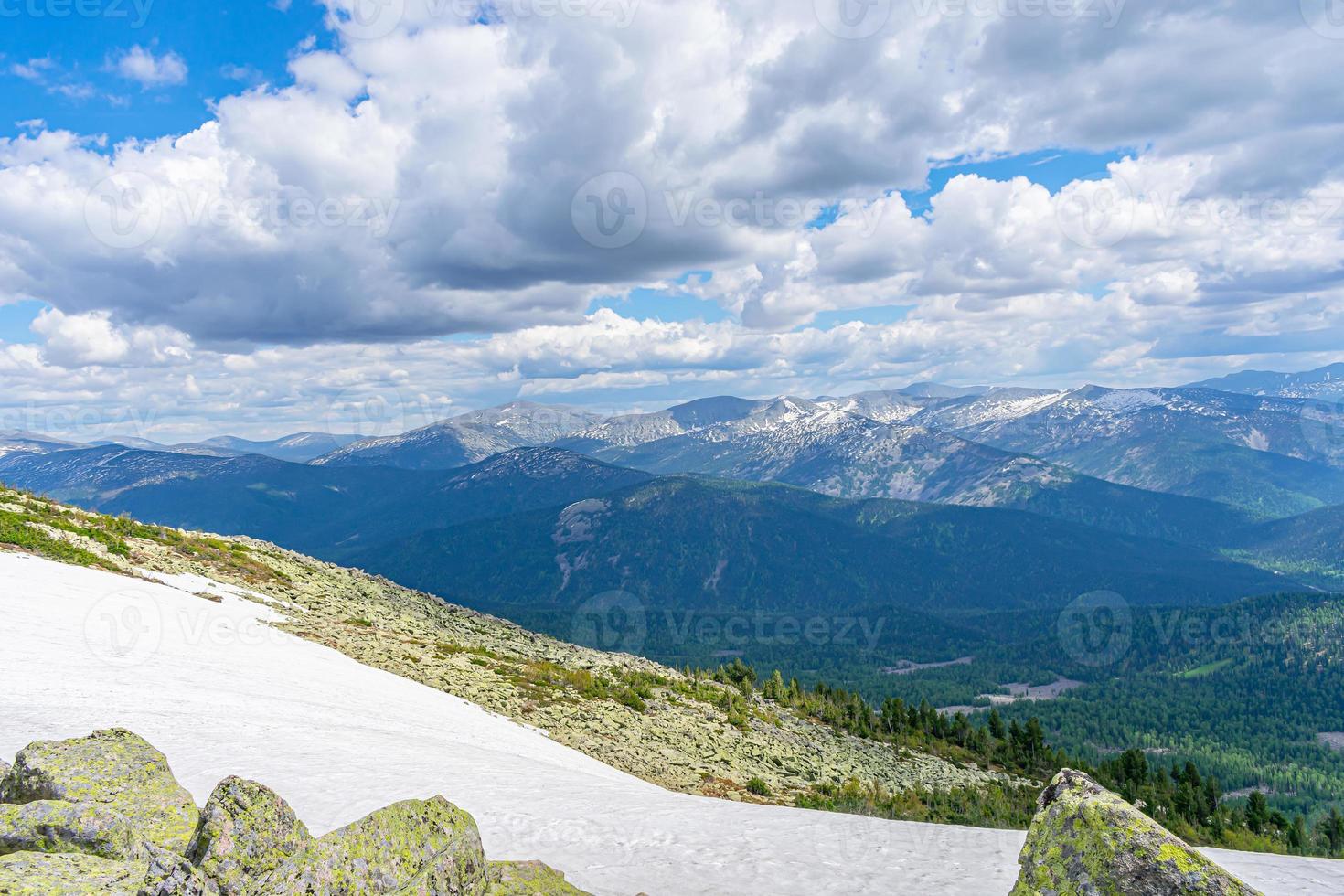 Landscape on the tops of low mountains with low flying clouds photo