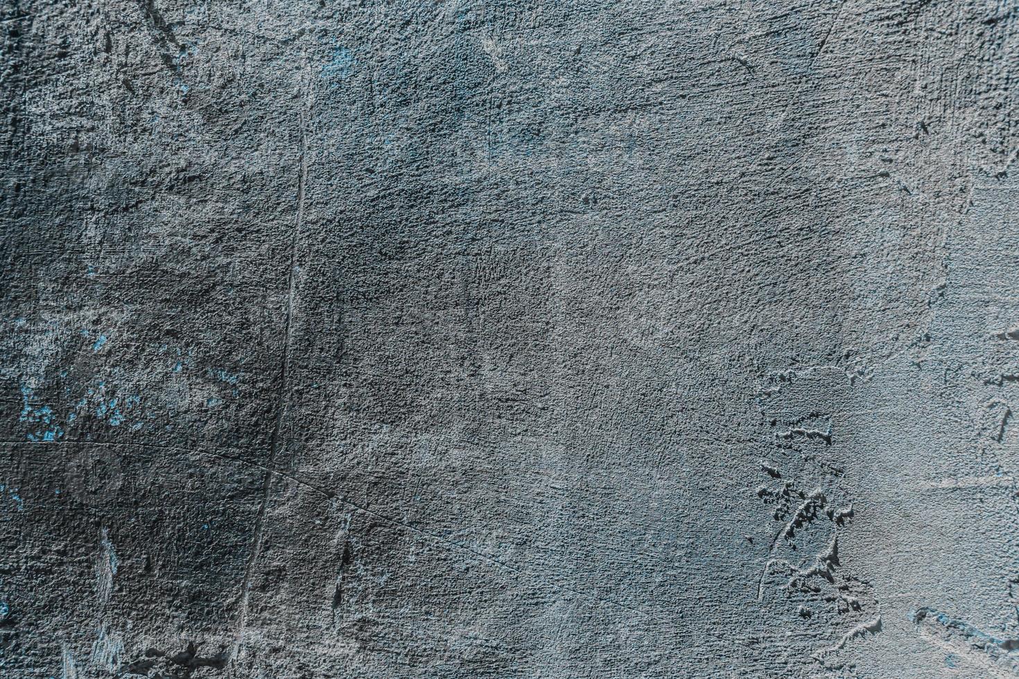 Texture, background, gray concrete wall with rough edges and scratches photo