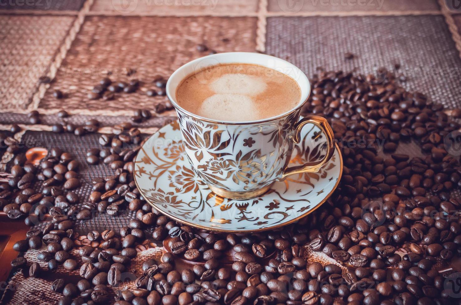 Cup of morning fresh fragrant coffee on a table with grains photo