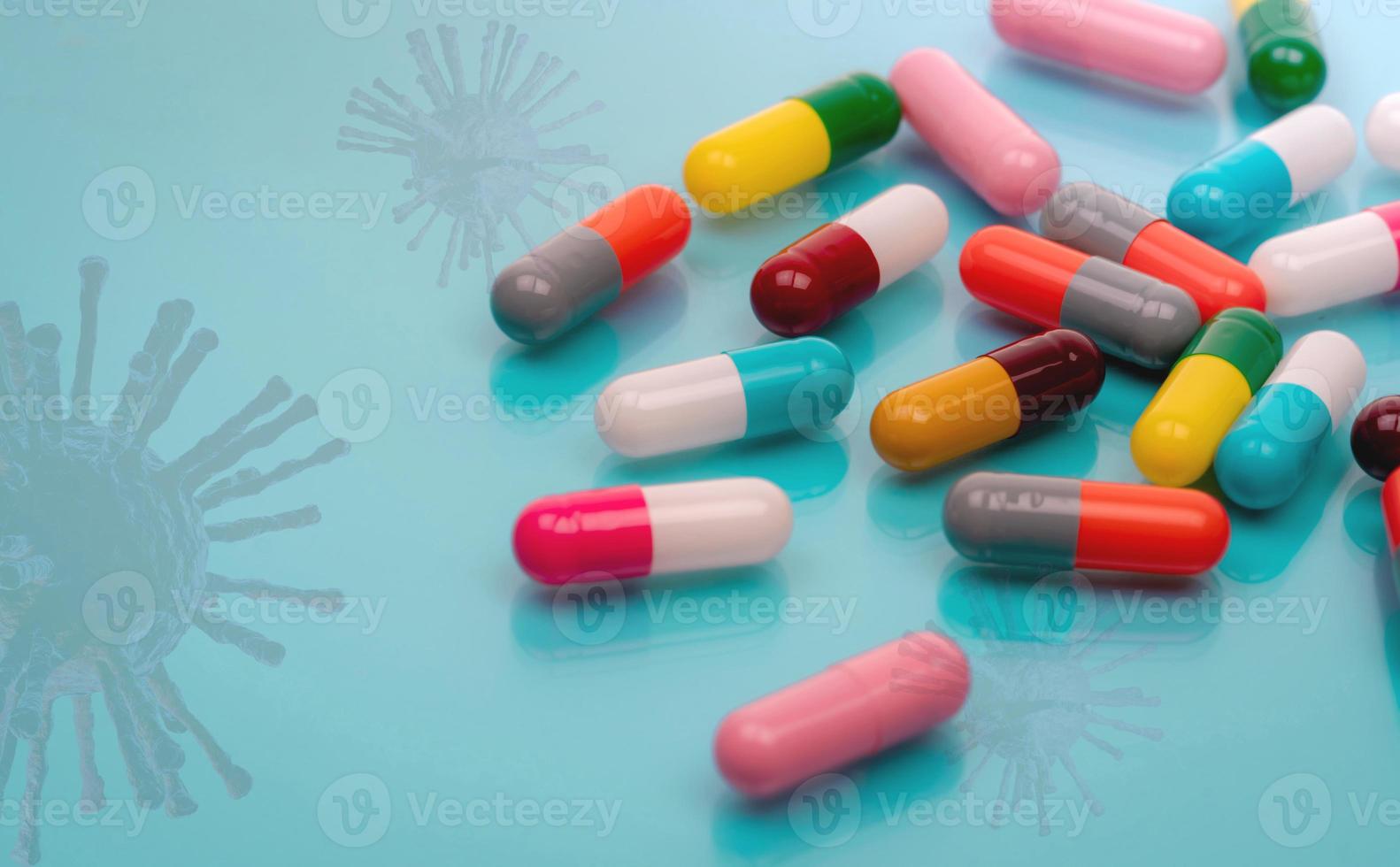 Antiviral capsule pills with virus on blue background. Drug development and new drug research for treatment emerging infectious diseases. Prescription drugs. Pharmaceutical industry. Pharmacology. photo