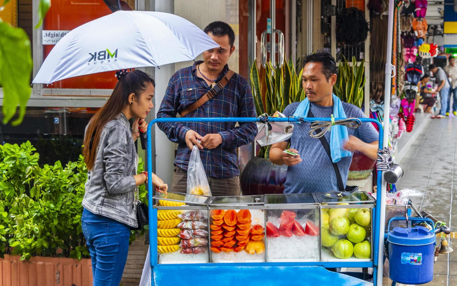 Ratchathewi Bangkok Thailand 2018 Buying food and fruits at a street food Bangkok Thailand. photo