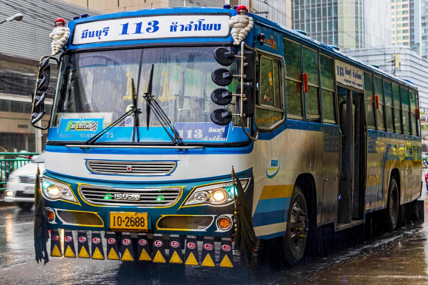 Huai Khwang Bangkok Thailand 2018 Typical colorful blue decorated bus in heavy rain Bangkok Thailand. photo