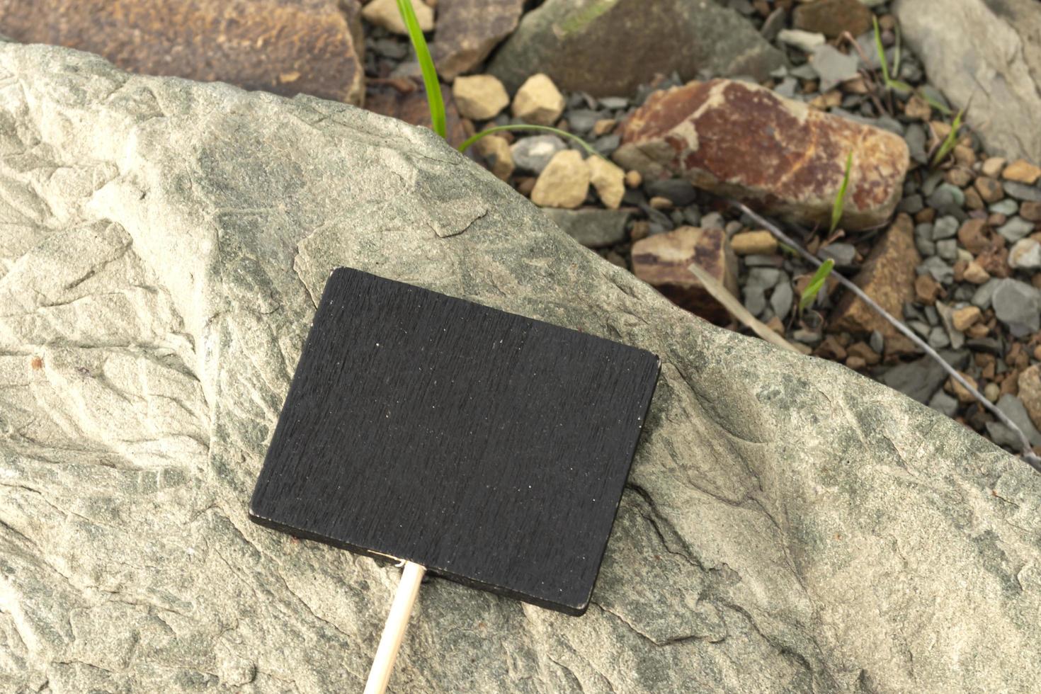 Chalkboard on stone beach background. Copy space. Directly above. photo