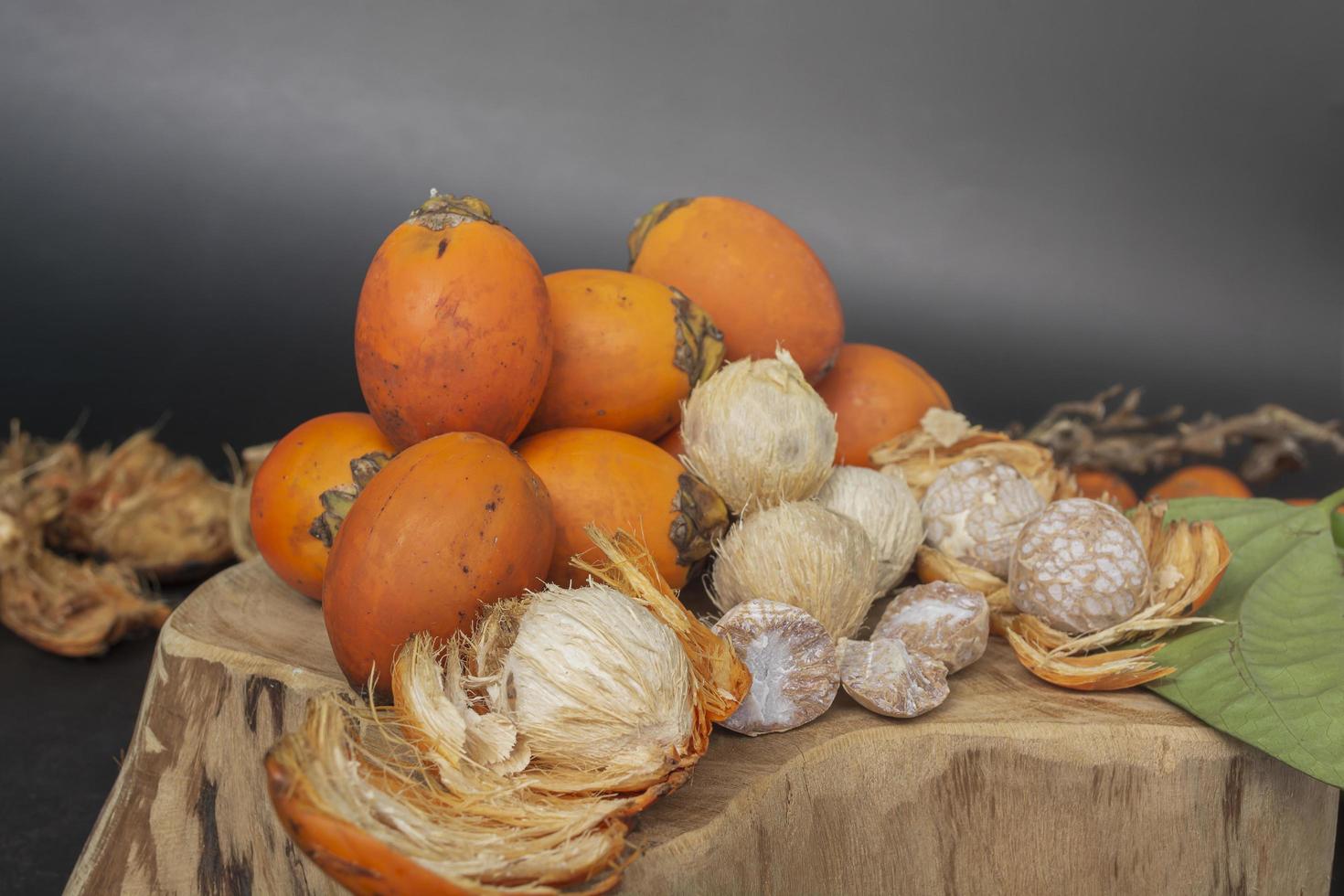 Betel nut or areca nut isolated on wooden background. photo