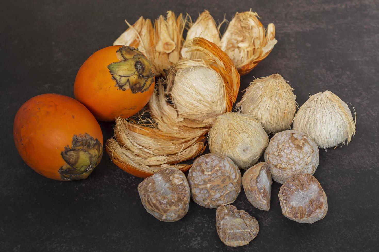 Ripe betel nut or areca nut isolated on dark background. photo