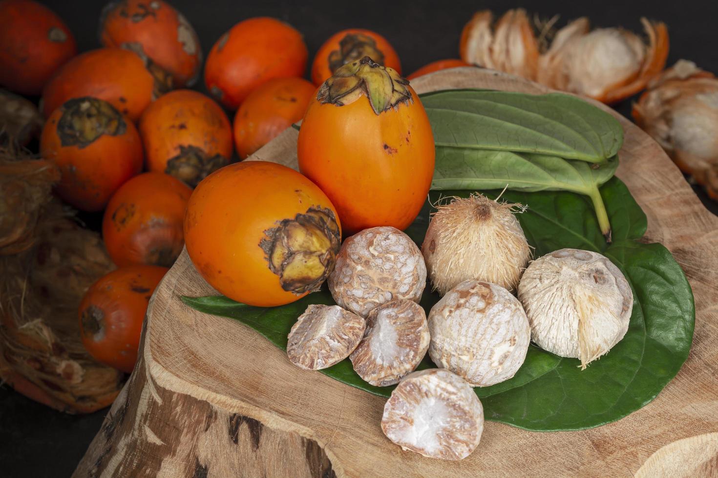 Betel nut or areca nut with betel leaf isolated on wooden background. photo