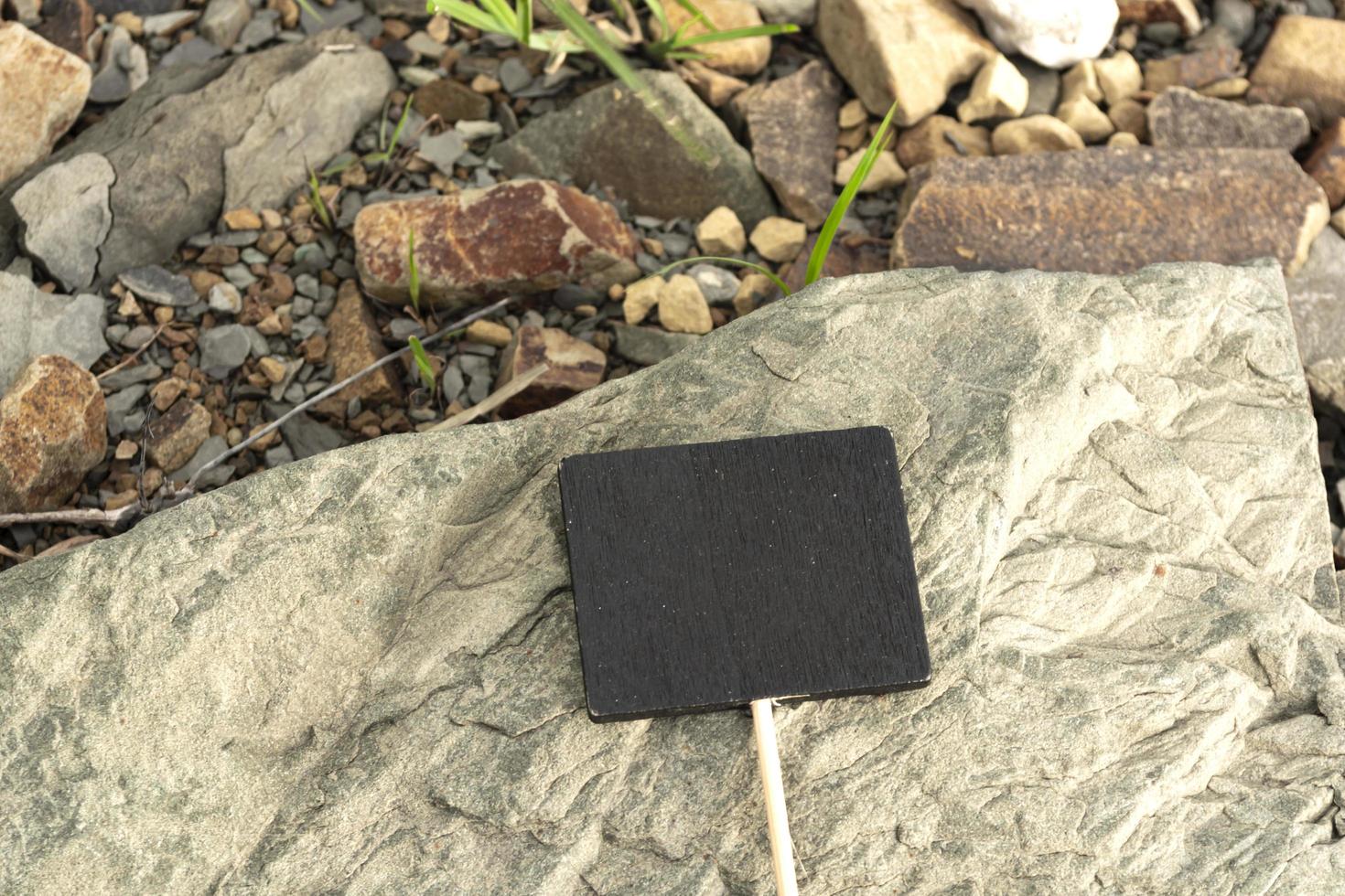 Chalkboard on stone beach background. Copy space. Directly above. photo