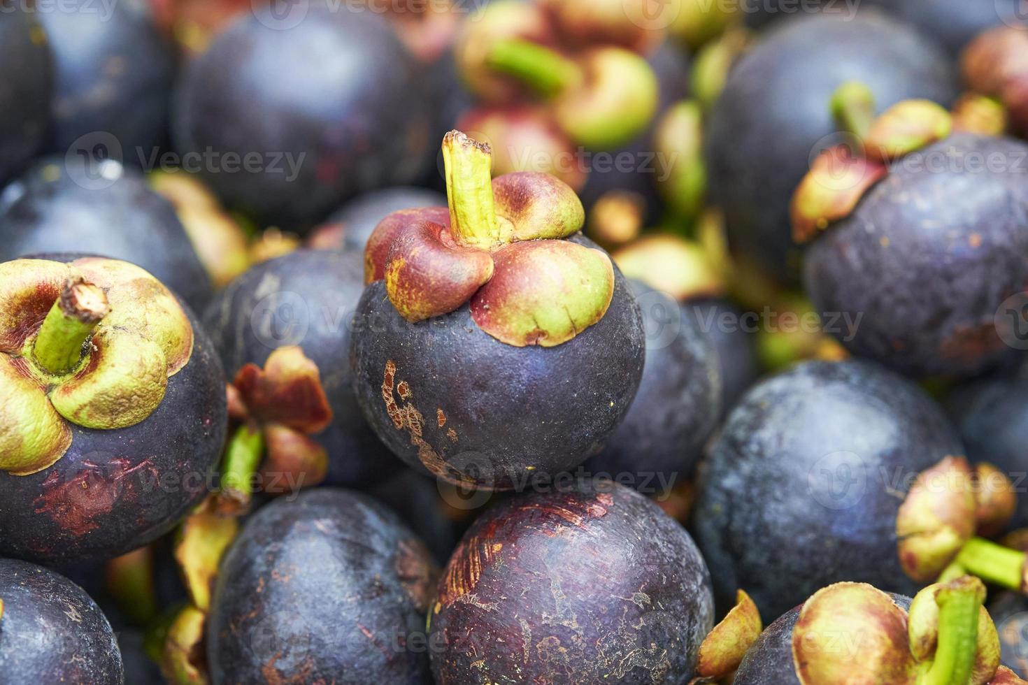 cerrar pila de fruta de mangostán, mercado de comida callejera tailandesa foto