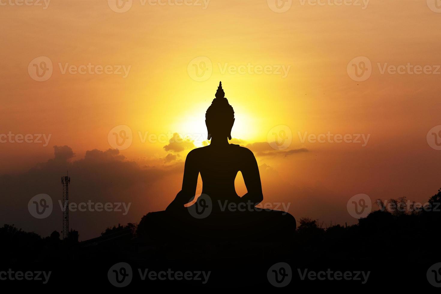 silhouette of buddha at sunset photo