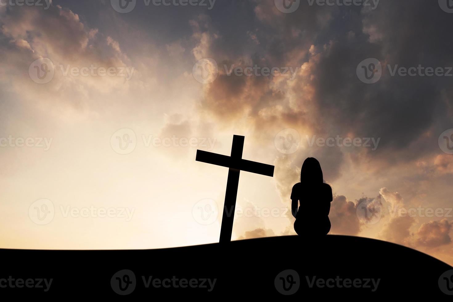 The cross and women on mountain sunset background photo