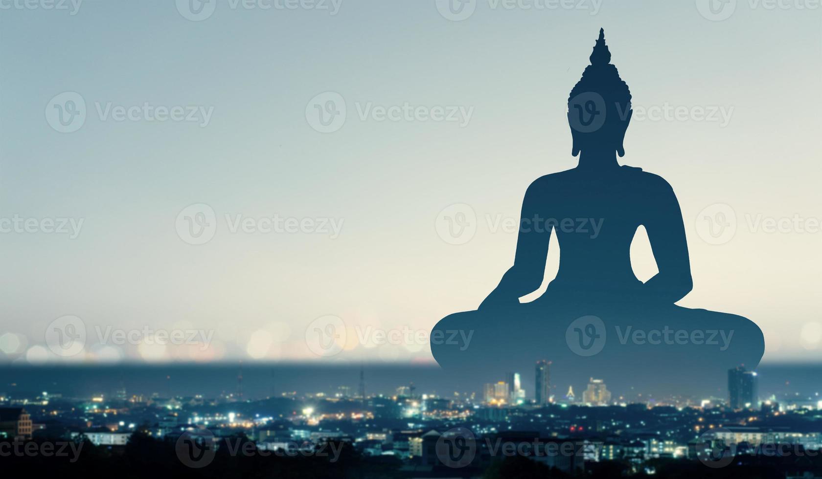 silhouette of buddha at sunset photo