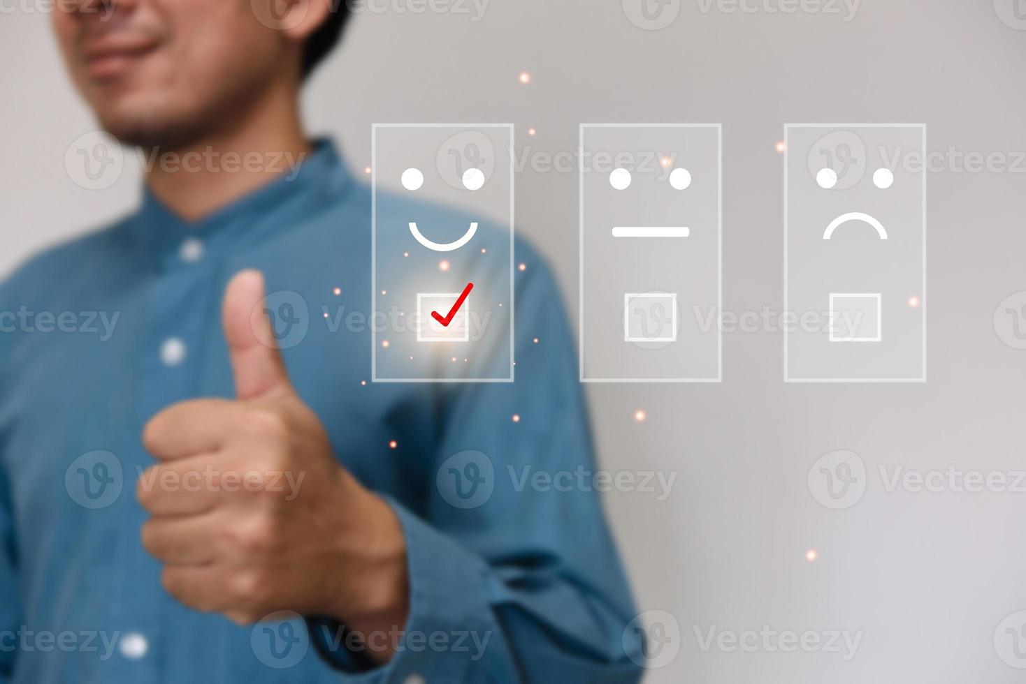 Businessmen wearing a light blue shirt to selecting the level of satisfaction score icons with copy space. Customer service experience and business satisfaction survey concept photo