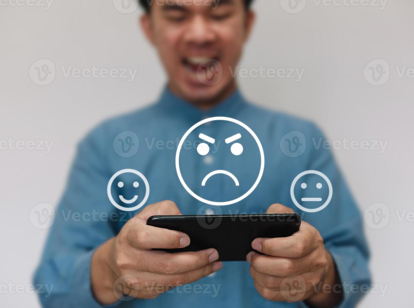 Businessmen wearing a light blue shirt to selecting the level of satisfaction score icons with copy space. Customer service experience and business satisfaction survey concept photo