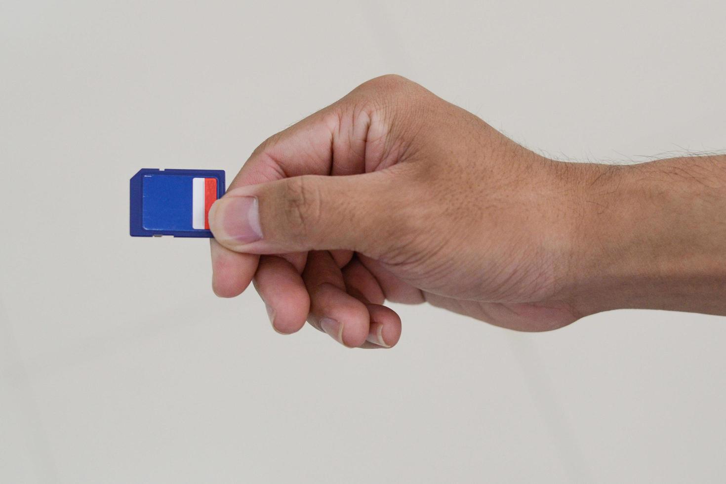 hand holding sd memory card. photo