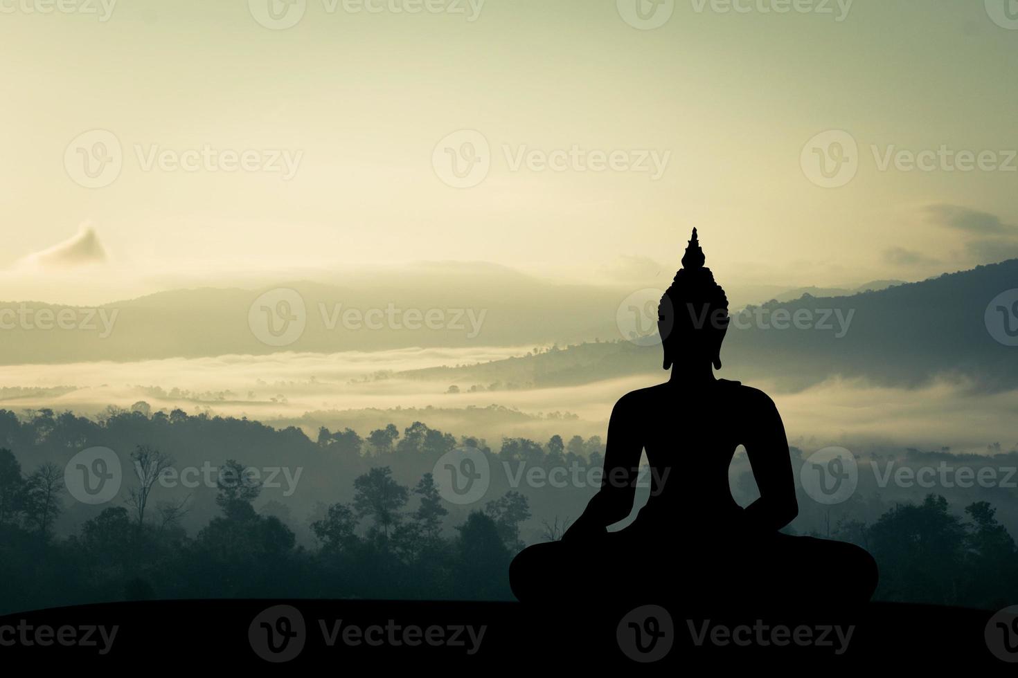 silhouette of buddha at sunset photo