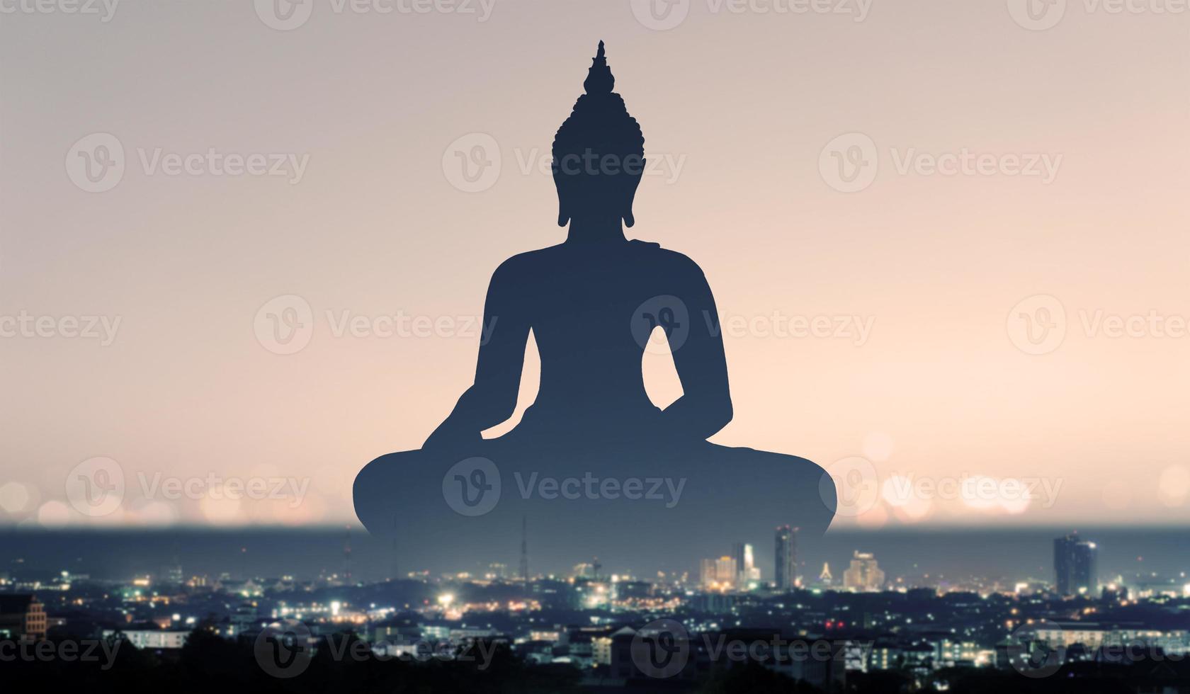 silhouette of buddha at sunset photo