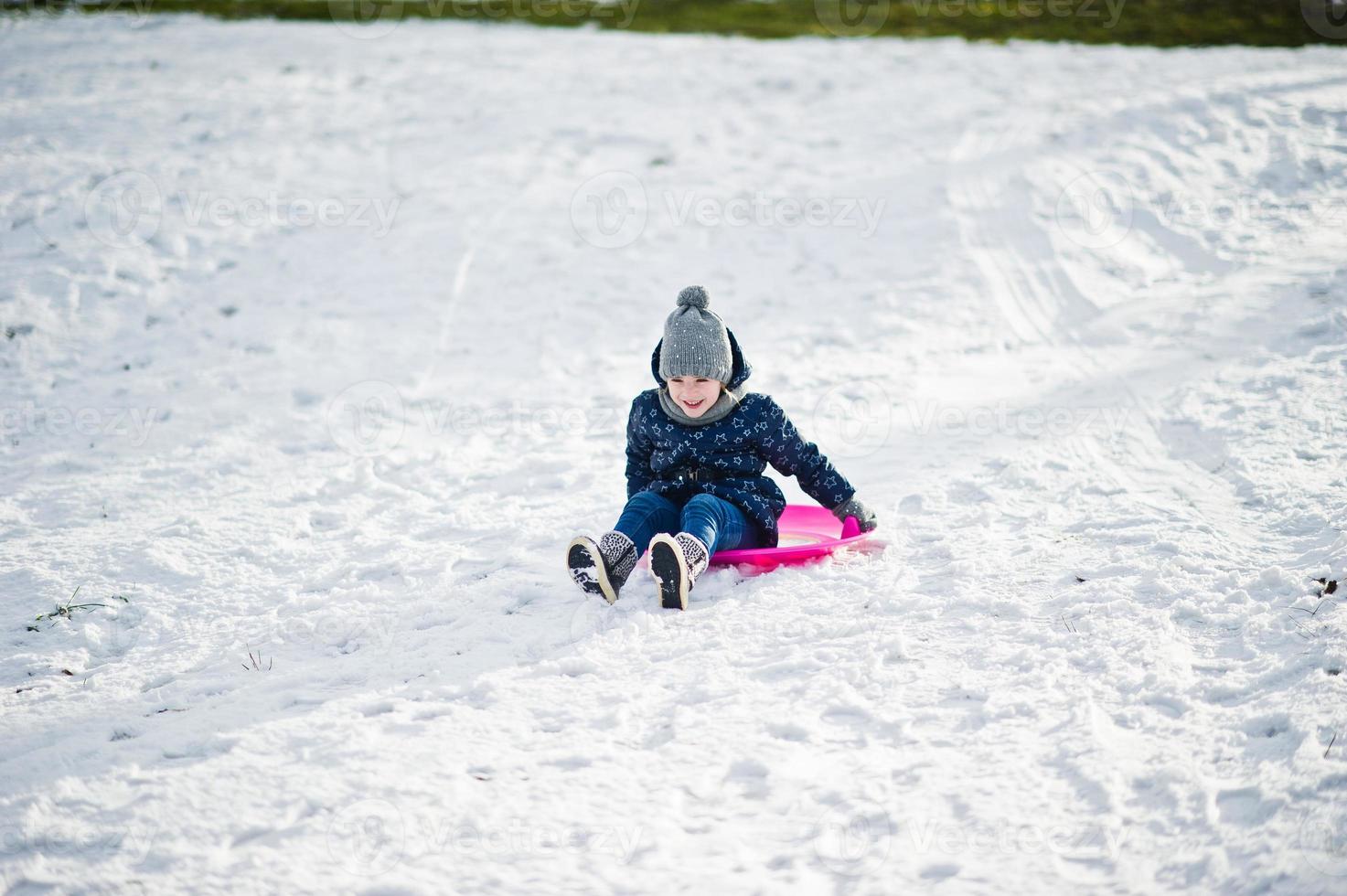 Cute little girl with saucer sleds outdoors on winter day. photo