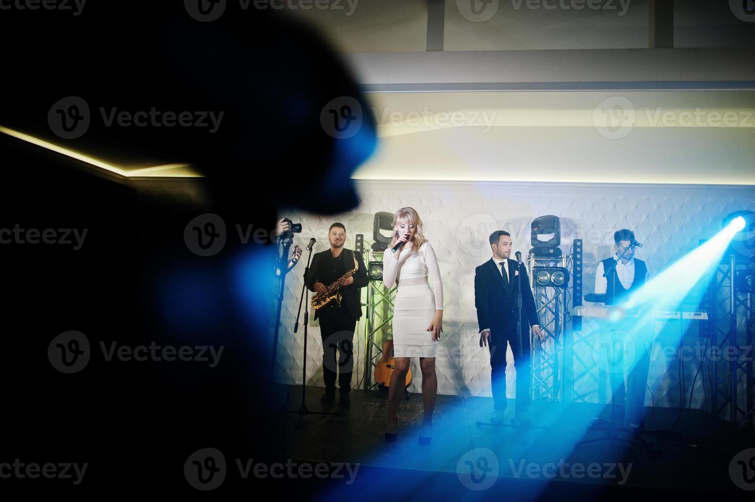 Musicial music live band performing on a stage with different lights. photo