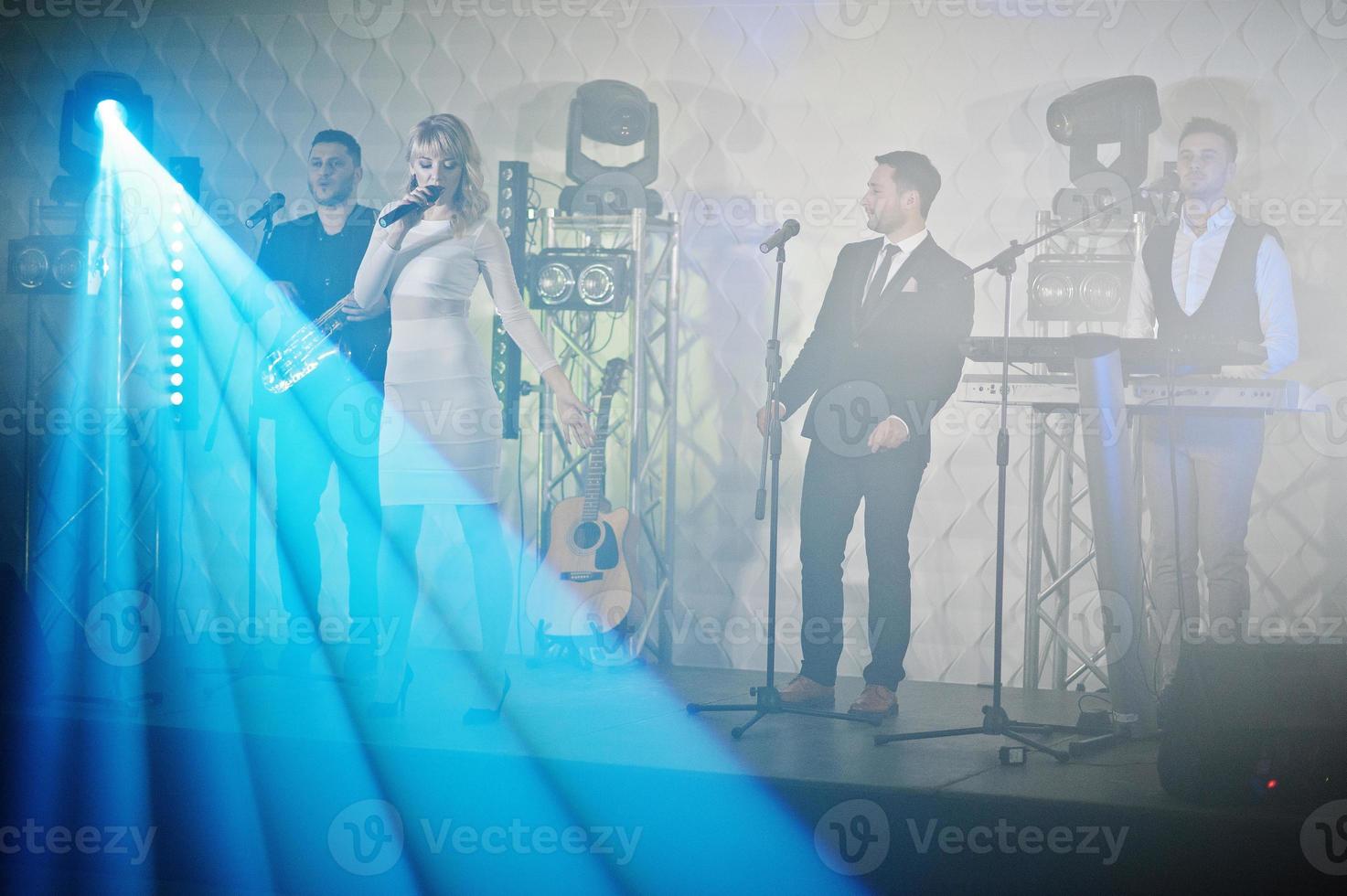 Musicial music live band performing on a stage with different lights. photo