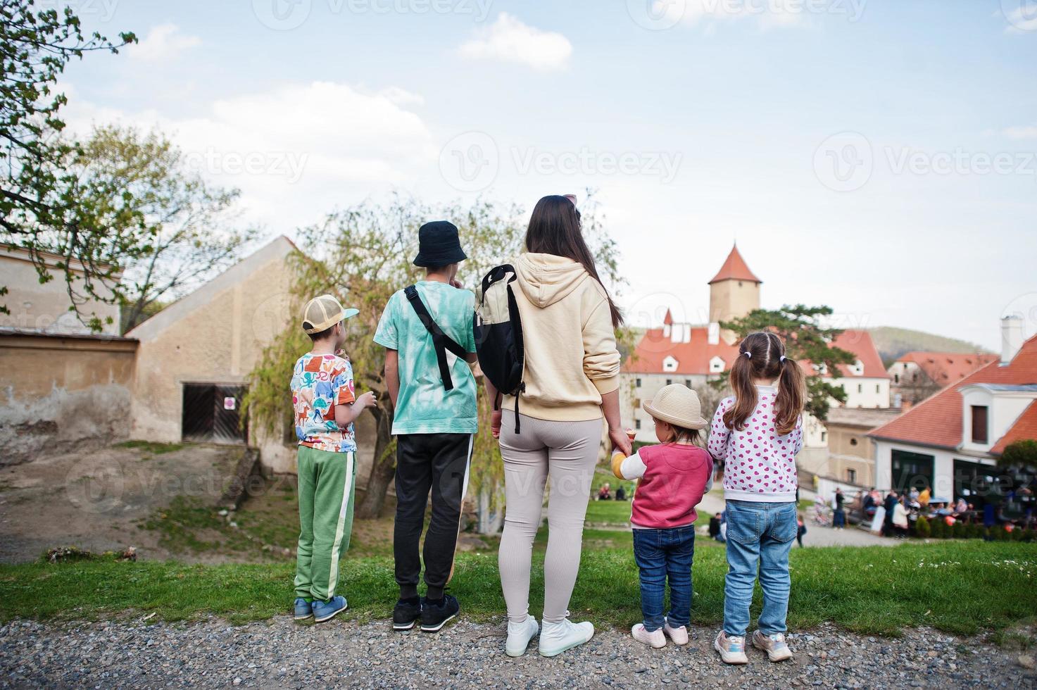 Back of mother with four children at Veveri castle, Czech Republic. Discover Europe concept. photo