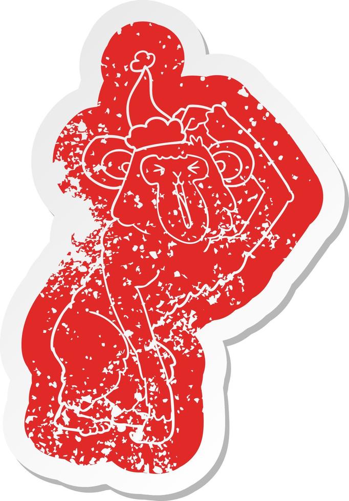 cartoon distressed sticker of a chimp scratching head wearing santa hat vector