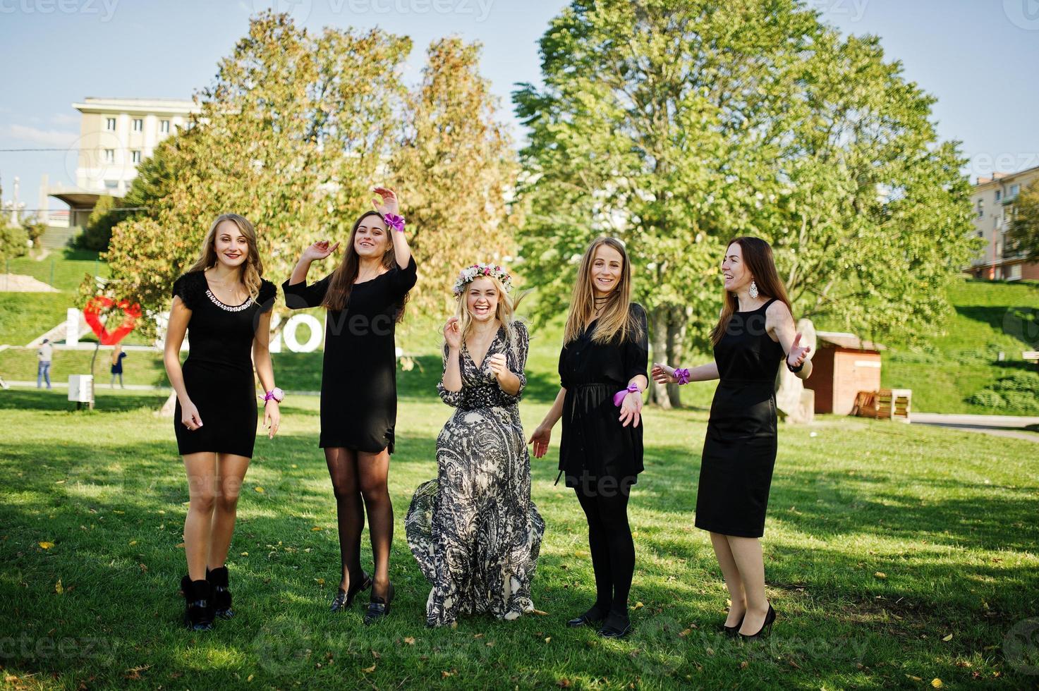 Five girls wear on black jumping at hen party. photo