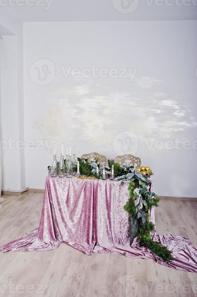 Table with candles and decor. Happy winter holidays concept. photo