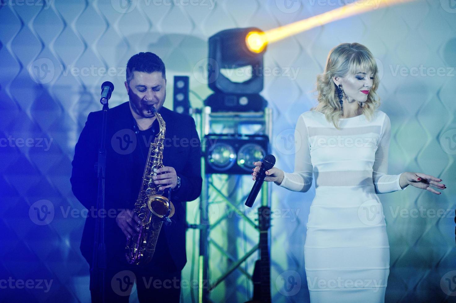 Musicial music live band performing on a stage with different lights. photo