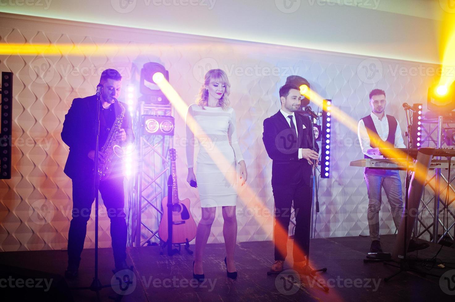Musicial music live band performing on a stage with different lights. photo