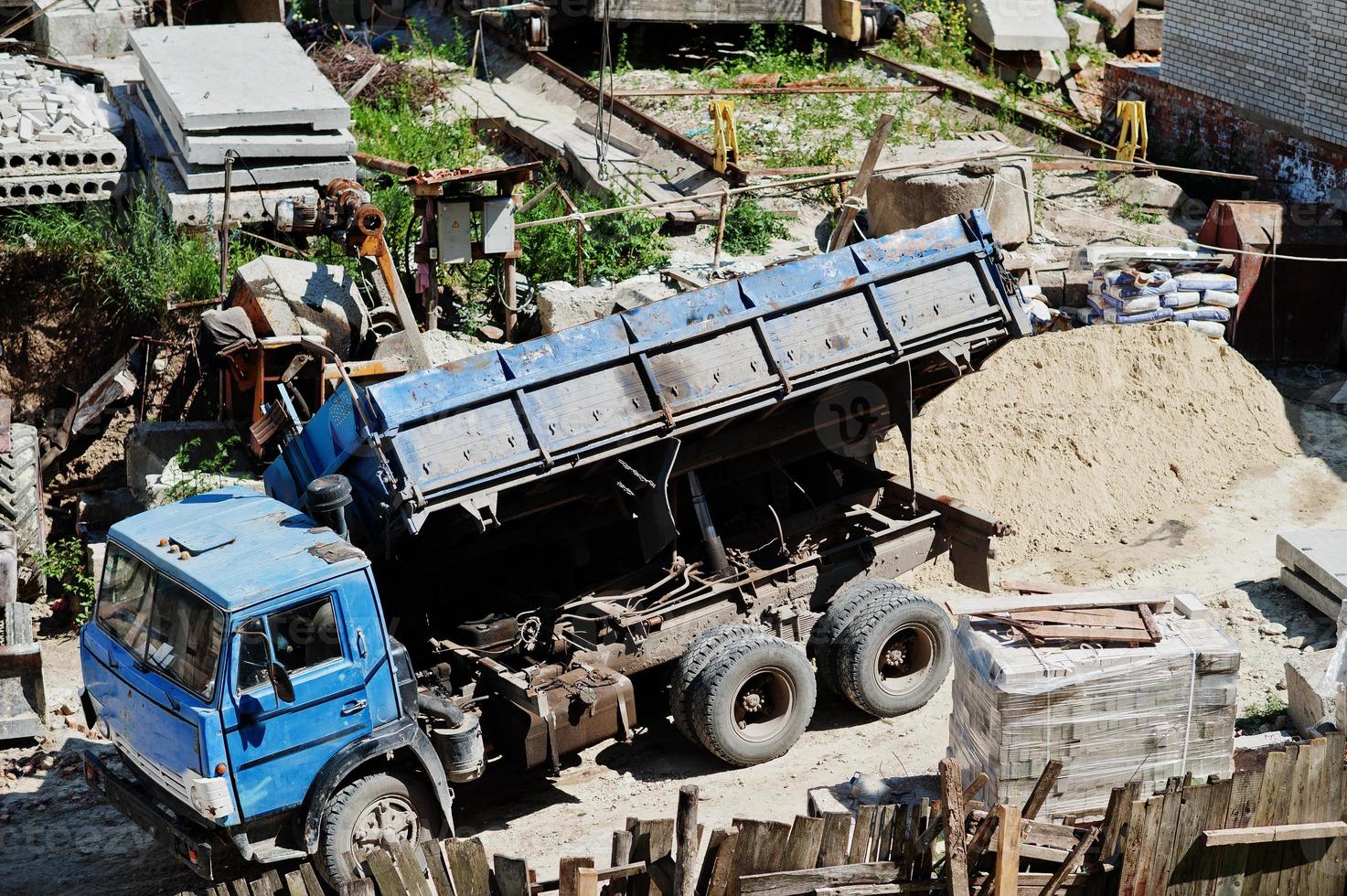 Enormous truck standing next to the construction work. photo