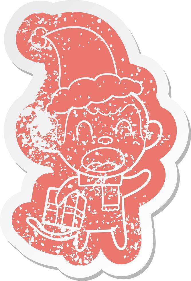 shouting cartoon distressed sticker of a monkey carrying christmas gift wearing santa hat vector