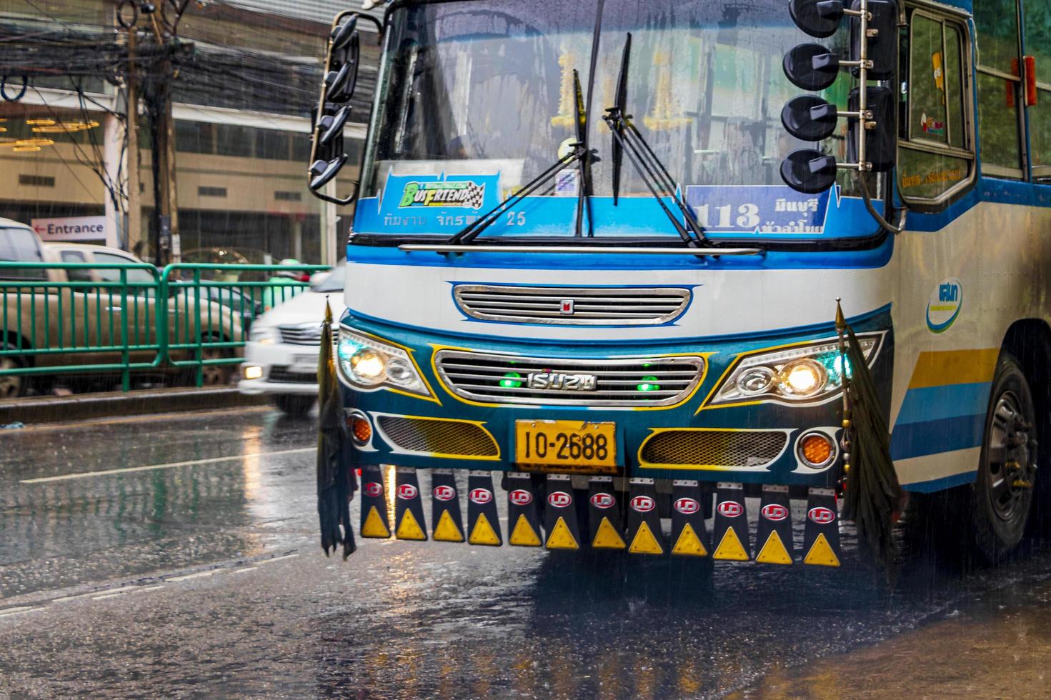 Huai Khwang Bangkok Thailand 2018 Typical colorful blue decorated bus in heavy rain Bangkok Thailand. photo