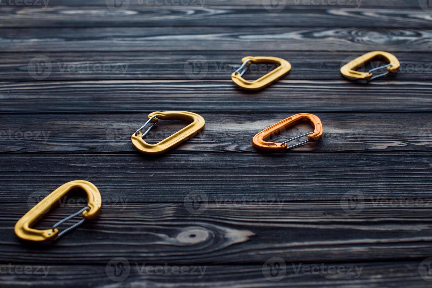 Take it for you extreme weekend activities. Isolated photo of climbing equipment. Parts of carabiners lying on the wooden table