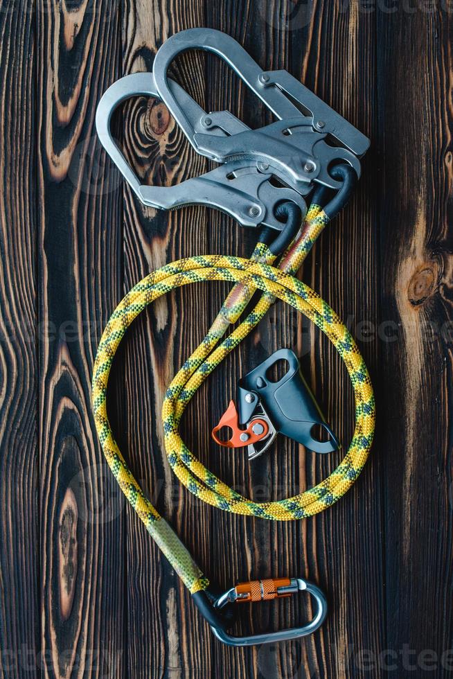 This is made for your safety. Isolated photo of climbing equipment. Parts of carabiners lying on the wooden table