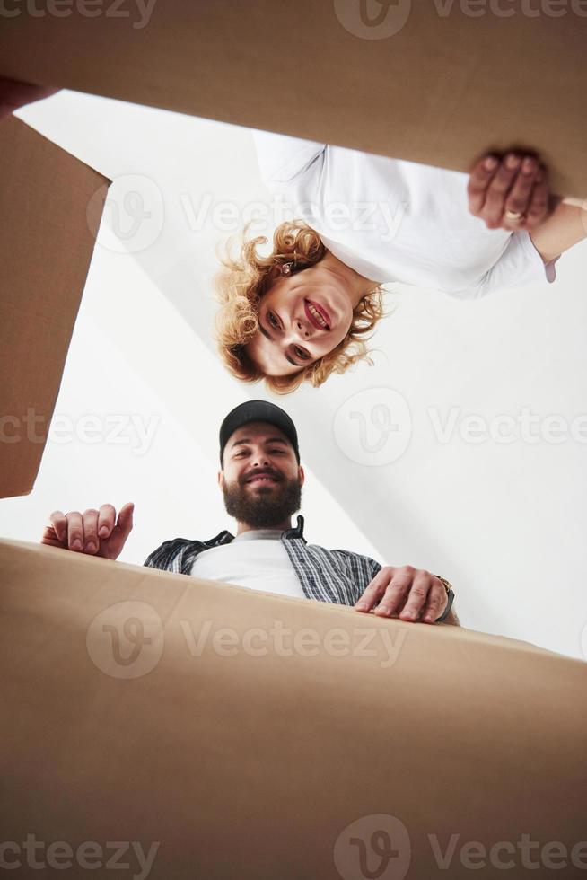 Vertical photo. Happy couple together in their new house. Conception of moving photo