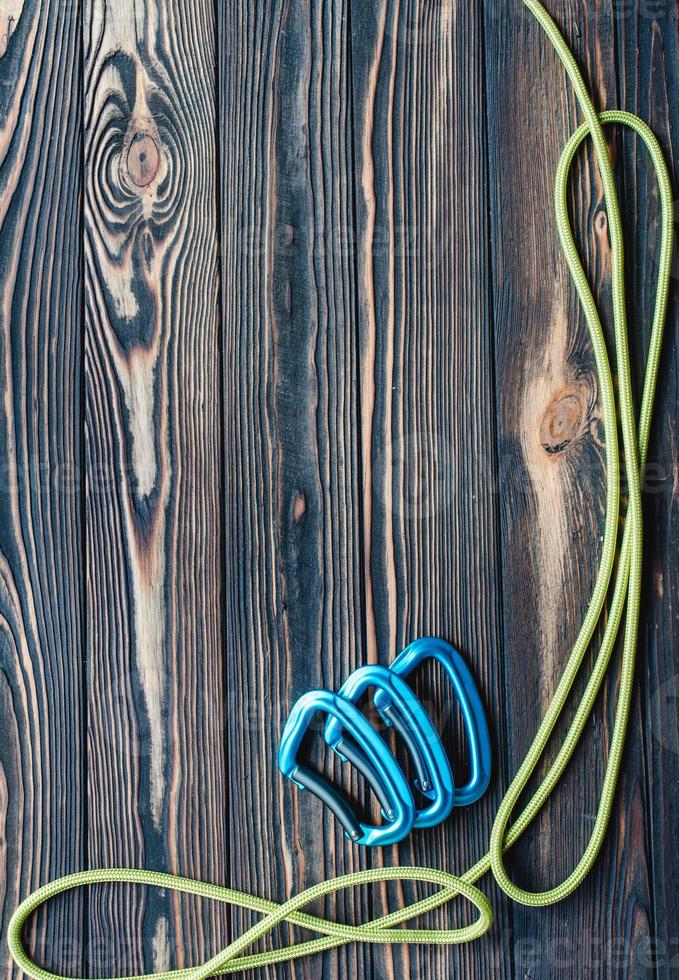 For the alpinism. Isolated photo of climbing equipment. Parts of carabiners lying on the wooden table