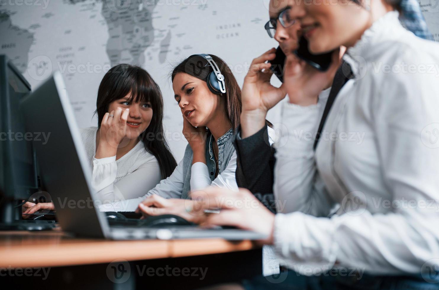 Employees have conversation. Young people working in the call center. New deals is coming photo