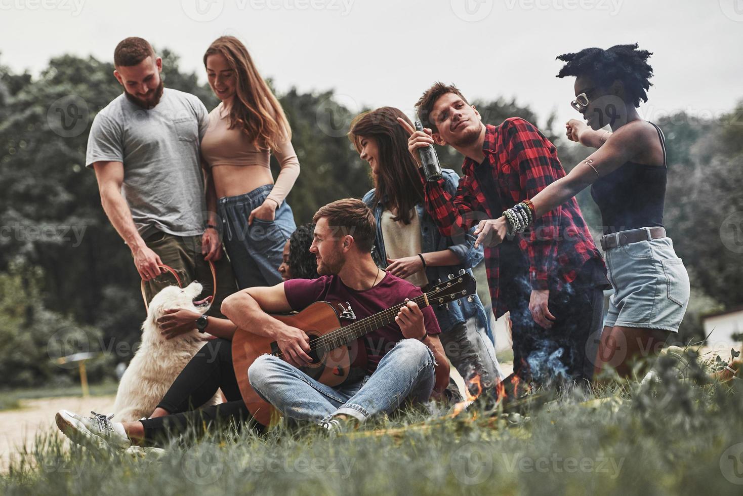 Everyone having good time. Group of people have picnic on the beach. Friends have fun at weekend photo