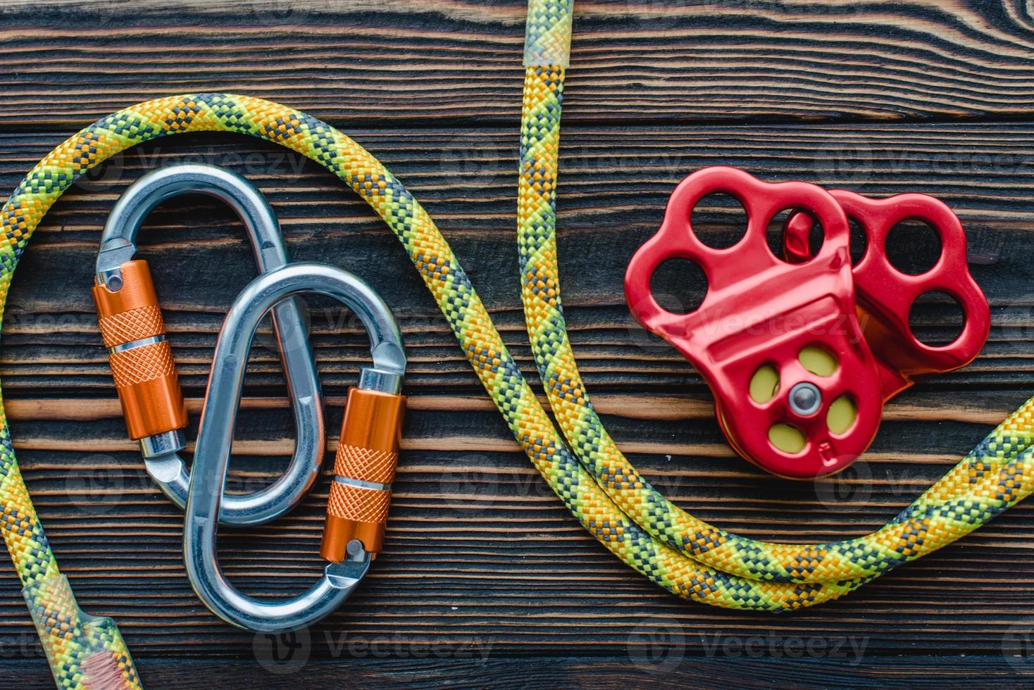 Stronger that it looks. Isolated photo of climbing equipment. Parts of carabiners lying on the wooden table