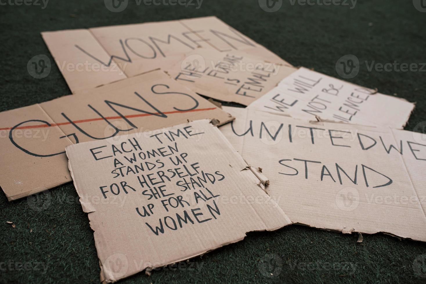 Messages for the people. Group of banners with different feminist quotes lying on the ground photo