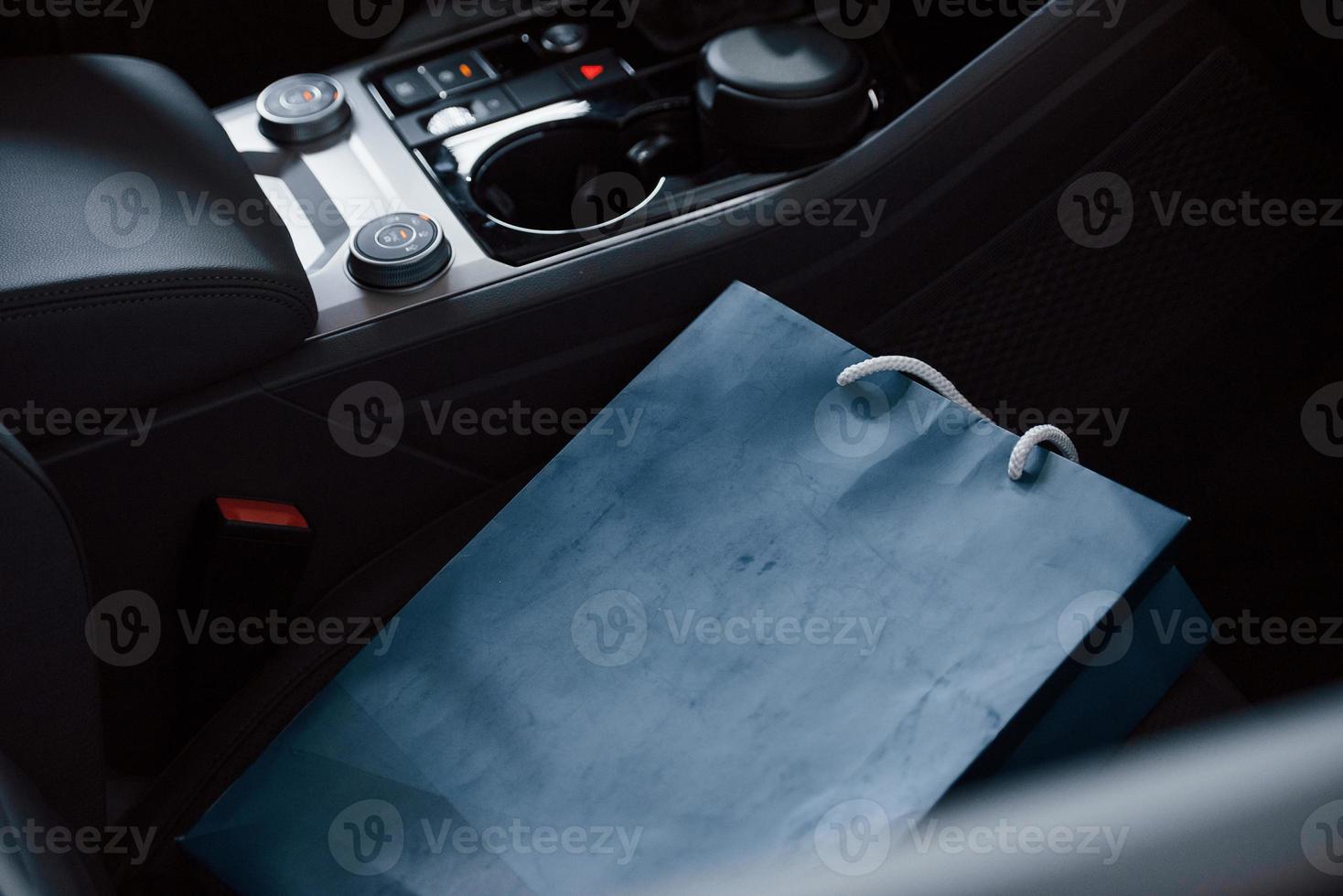 Blue bag lying in car. Close up view of interior of brand new modern luxury automobile photo