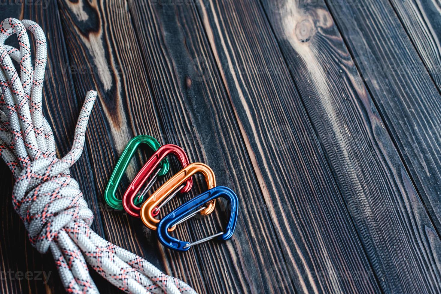 No one. Isolated photo of climbing equipment. Part of carabiner lying on the wooden table