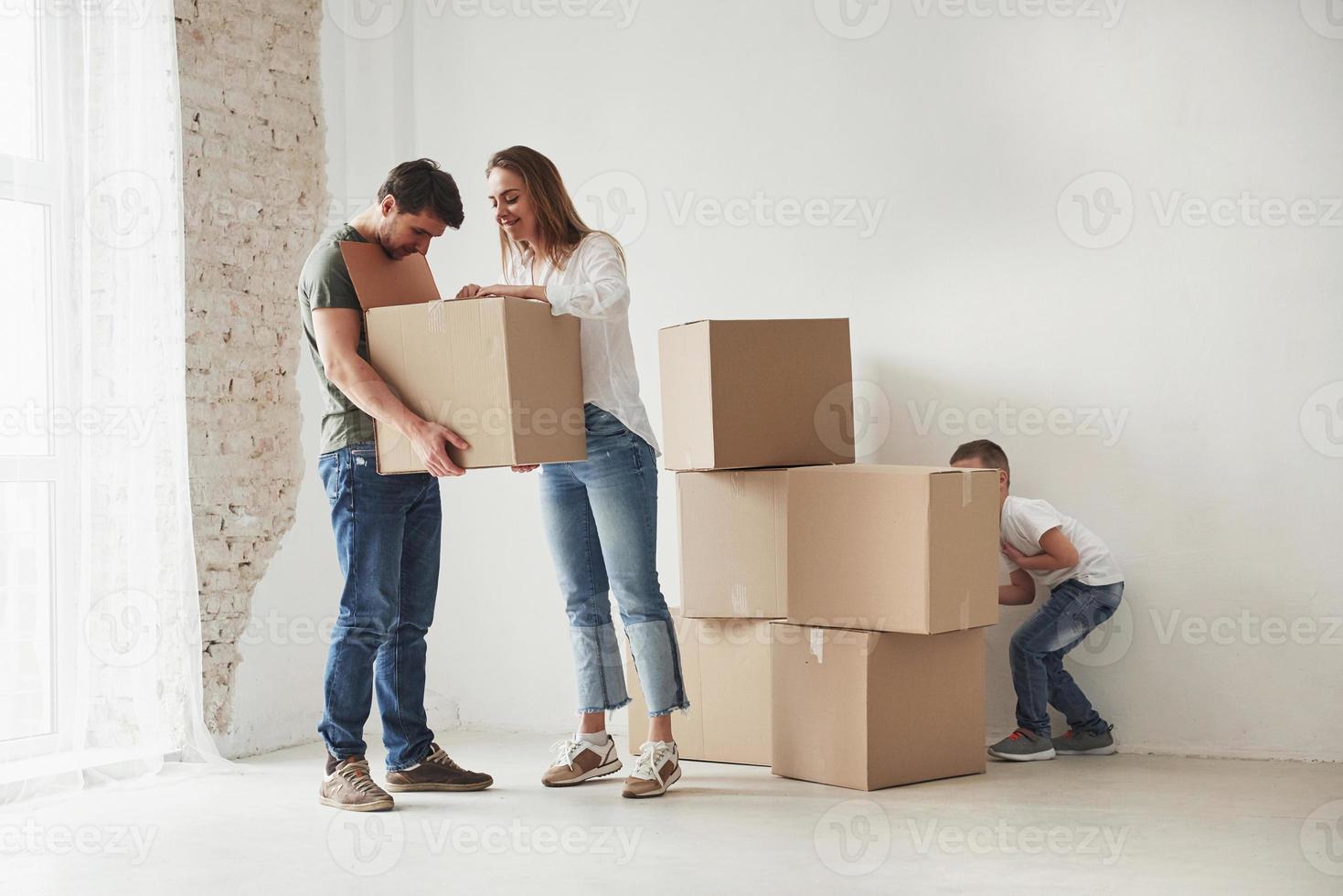 Hiding behind the boxes. Family have removal into new house photo
