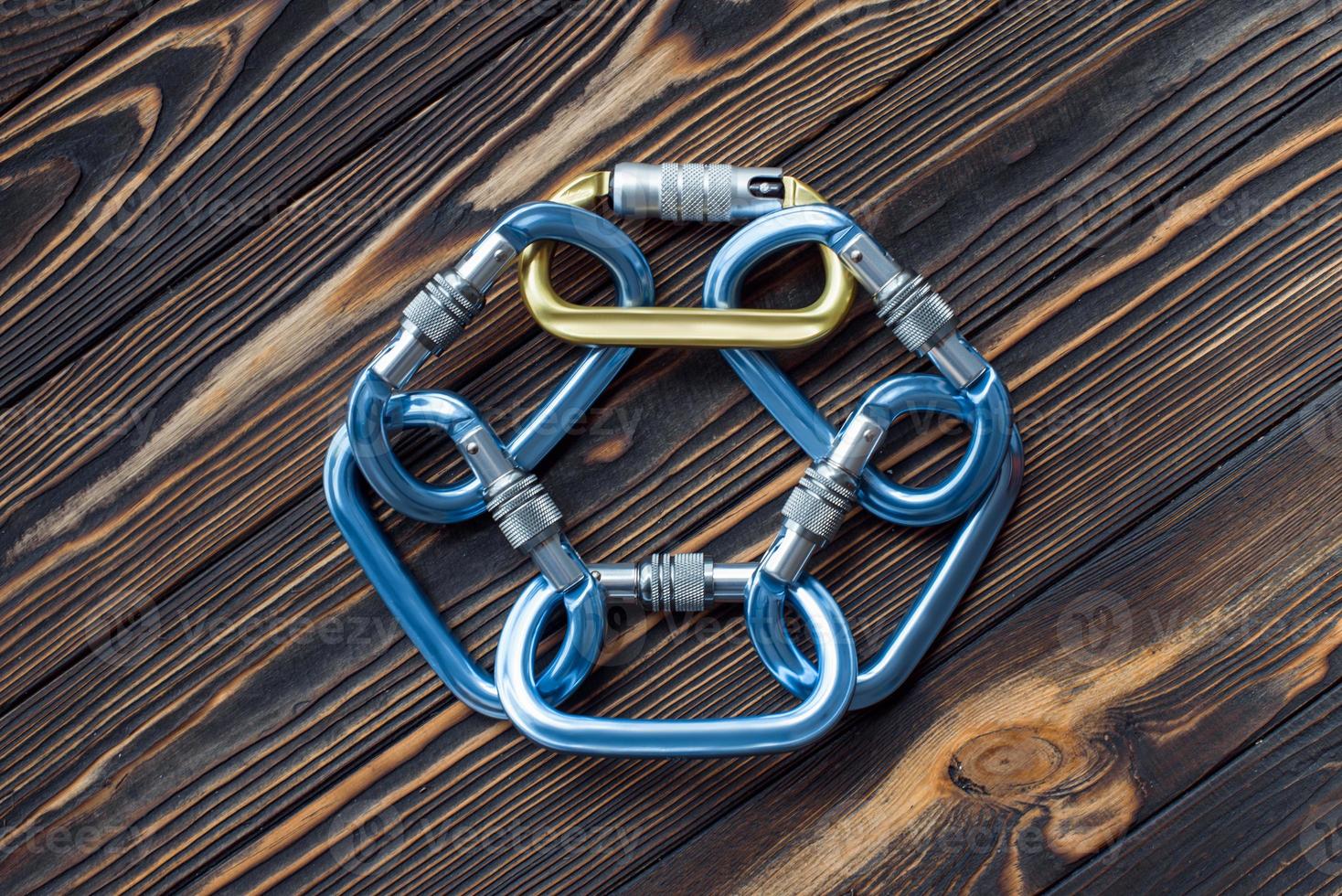 For the leisure activities. Isolated photo of climbing equipment. Parts of carabiners lying on the wooden table