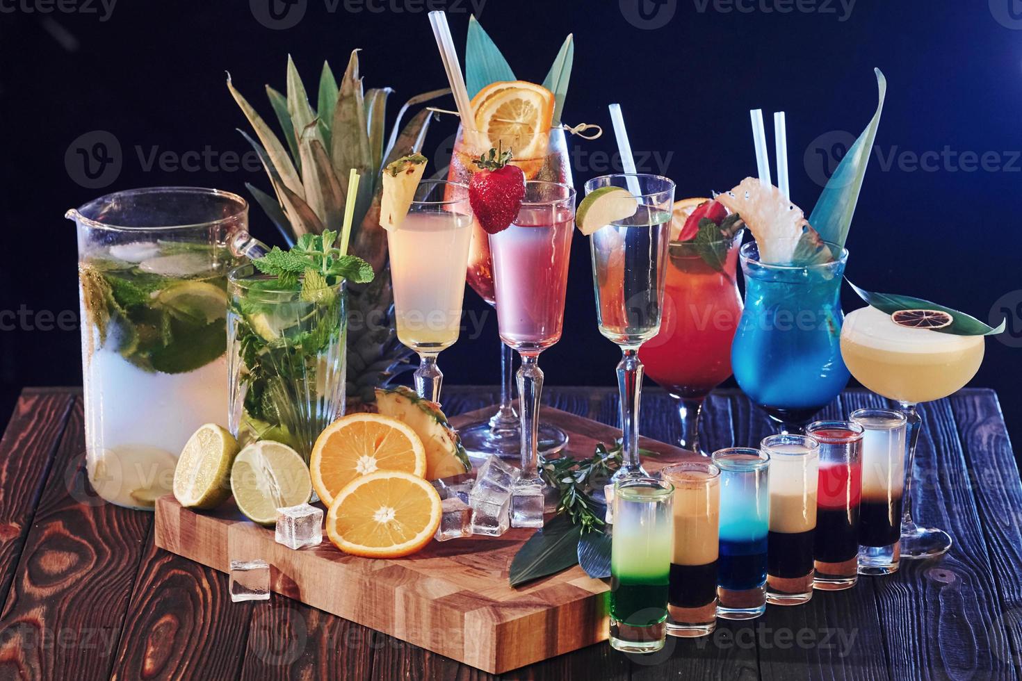 Set of many different cocktails. Drinks is ready. On the wooden table in the night club. Nice lighting photo