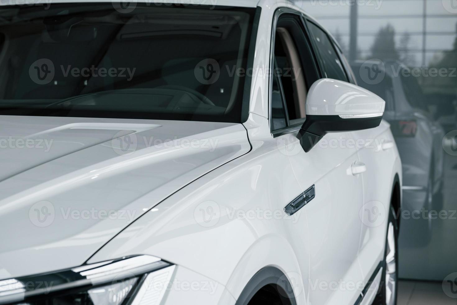 Ready for the ride. Particle view of modern luxury white car parked indoors at daytime photo