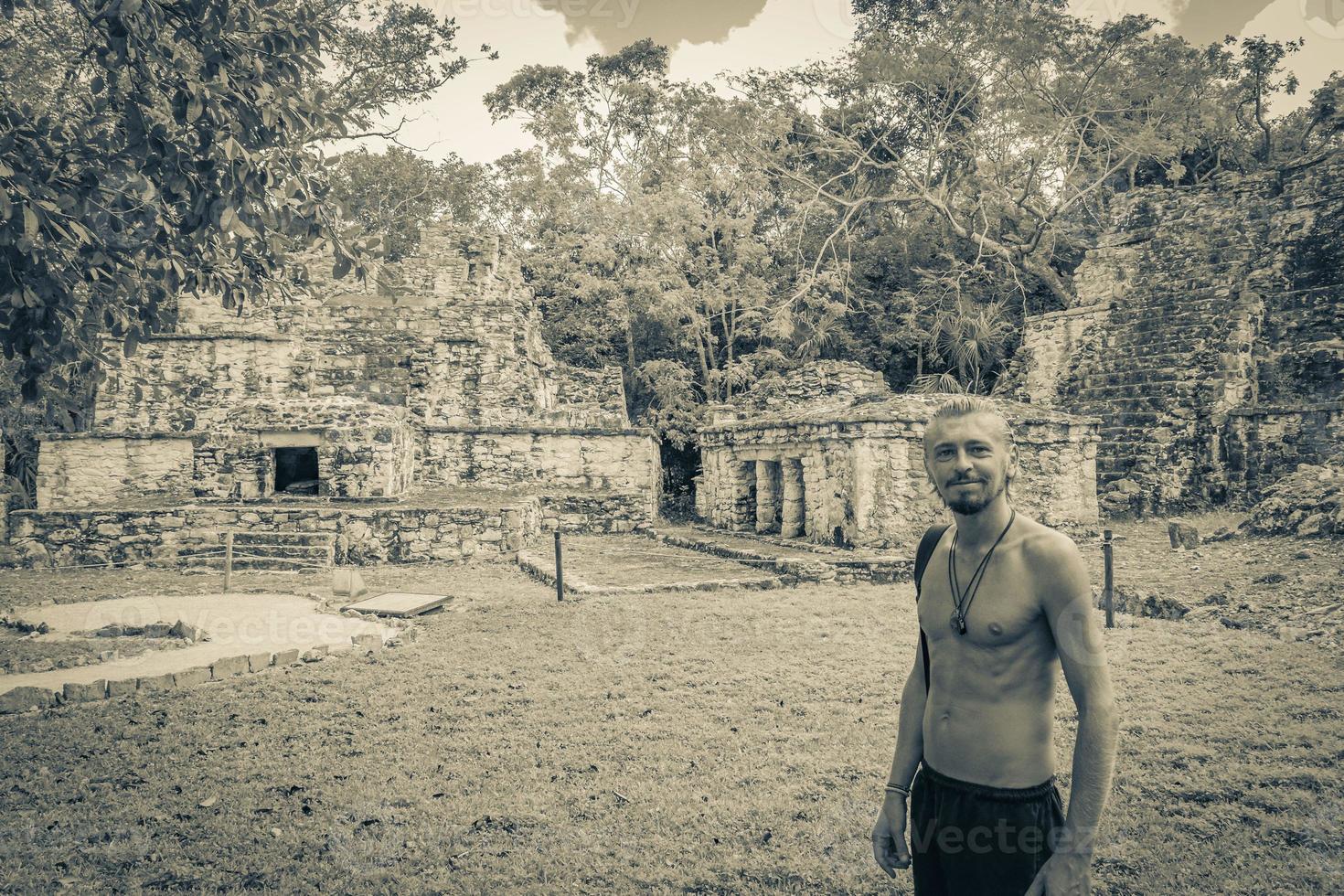 Tourist guide ancient Mayan site temple ruins pyramids Muyil Mexico. photo